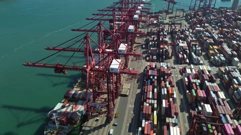 Cargo containers stacked during unloading at shipping dock Stock Footage 334116904