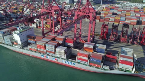 Cargo containers stacked during unloading at shipping dock Stock Footage 335552105