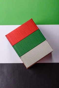 Cargo containers on the UAE flag as a conceptual backdrop for goods export... Stock Photos
