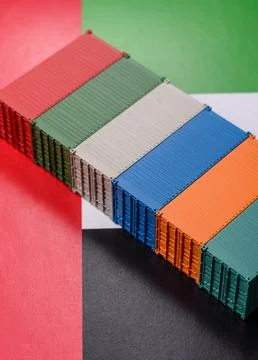 Cargo containers on the UAE flag as a conceptual backdrop for goods export... Stock Photos