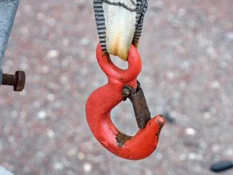 Cargo crane hook in red with rust  hanging Stock Photos