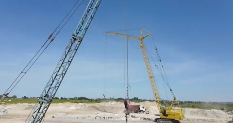 A cargo crane lifts cargo at a construction site Stock Footage 243352706