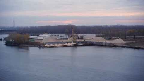 Cargo crane in river port makes unloading of rubble barge, Stock Footage 118266742
