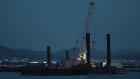 Cargo crane working in small port, construction of industrial harbor or dock Stock Footage 148443687