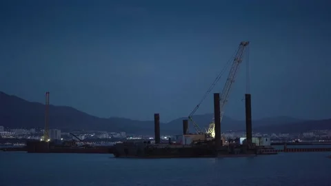 Cargo crane working in small port, construction of industrial harbor or dock in Stock Footage 151928356