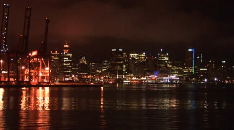 Cargo Cranes and City Lights in Bay Stock Footage 33604885