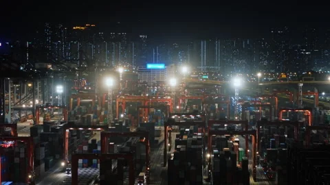 Cargo Cranes Loading And Unloading Containers On Trucks In A Busy Illuminated Stock Footage 312858230