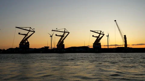 Cargo cranes at sunset. 4K footage. Stock Footage 130064575