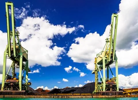 Cargo crranes loading coal in the harbor of Antwerp Stock Photos