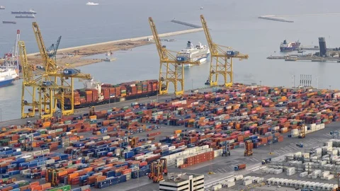 Cargo dock with colored containers. Trucks and cranes coming and going. Panning Video stock 109545906
