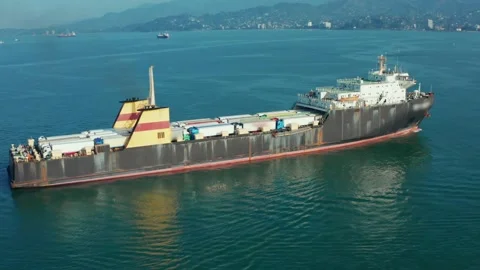 Cargo freight ship with containers and trucks, aerial view from drone Video stock 226244545