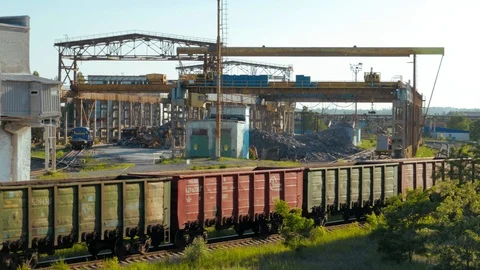 Cargo freight train wagons go on railroad in industrial zone with plants of Stock Footage 91191084
