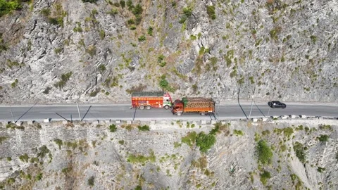 Cargo freight trucks navigating dangerous road in himalayan mountains  Stock-Footage 337627352