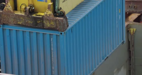 Cargo glows under dull light framed by cranes and towers Stock Footage 319833064