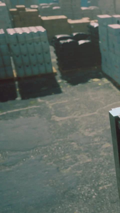 Cargo handling at a loading dock in bright daylight near storage containers Stock Footage 334172196