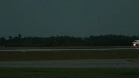 Cargo jet in background at dusk Stock Footage 112605