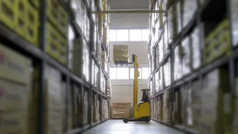 The cargo is lifting in a large warehouse Stock Footage 75632691