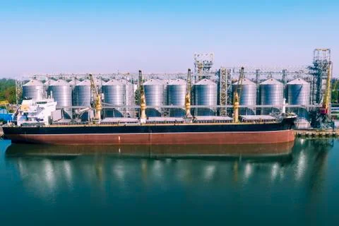 Cargo loading on a ship. Shipping cargo to harbor by ship. Water transport In Stock Photos