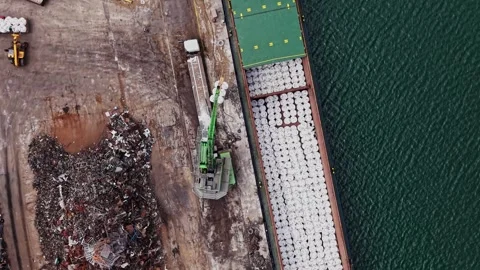 Cargo loading at the shipping dock by the water in broad daylight 動画素材 338324865