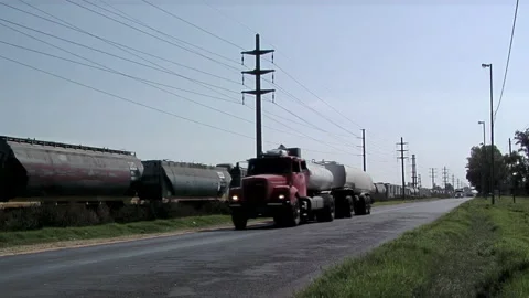 Cargo Logistics, Freight Train and Fuel Truck on Parallel Routes, Argentina Stock Footage 145468732