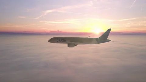 Cargo plane flying over clouds tracking Stock Footage