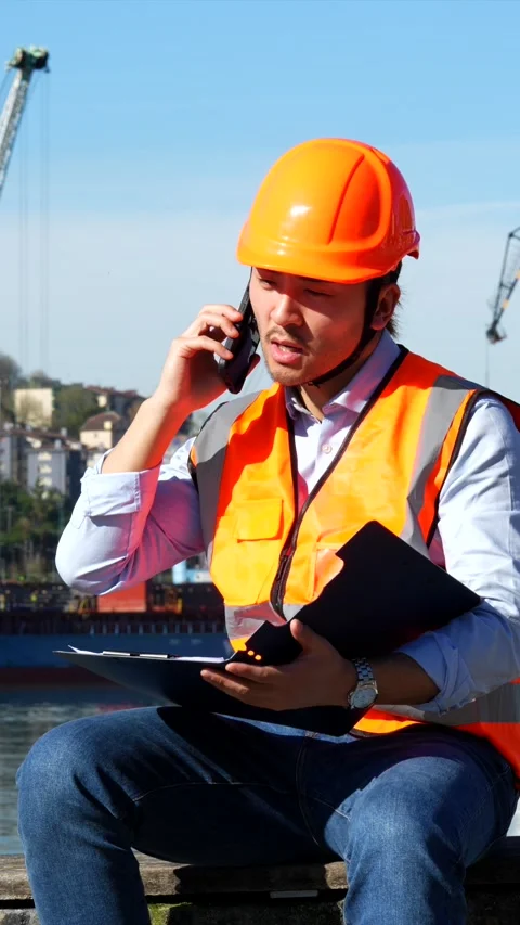 Cargo port foreman managing logistics on the phone Stock Footage 333731391