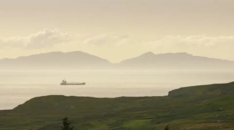 Cargo Ship and Mountainous Background at Sunset Stock Footage 66690947