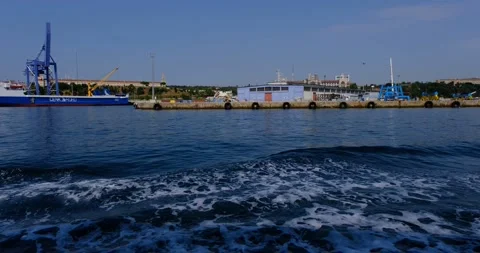 Cargo Ship and Port Infrastructure with City Background Stock Footage 211746625