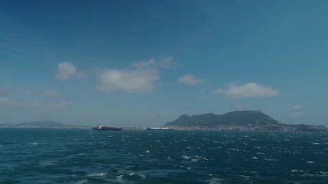 Cargo Ship and Rock of Gibraltar Seen From Sea Between Spain and Morocco Stock Footage 340595901
