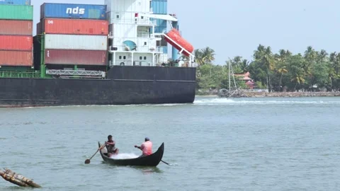 Cargo ship and rowing boat Stock Footage 147554570
