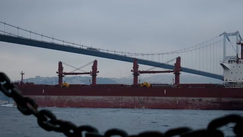 The cargo ship that appears behind the chain passes through the Bosphorus. Stock Footage 123817585