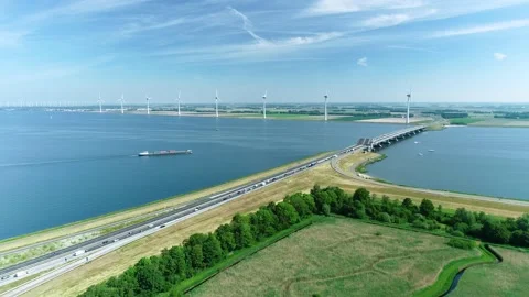 Cargo Ship Approaching a Bridge between Lakes - Flevoland, Holland, 4K Drone Stock Footage 145926906