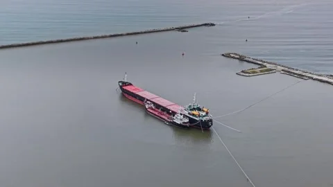 Cargo ship arrives at shipyard for unloading in busy transport area 스톡 동영상 337941080