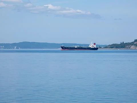 Cargo ship in a bay along the puget sound near pacific ocean Stock Photos