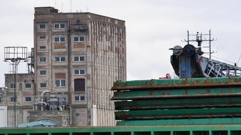Cargo ship being loaded with reddish earth Stock Footage 72787705