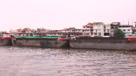 Cargo ship being towed by boats on the Chao Phraya River, Thailand Stock Footage 157605345