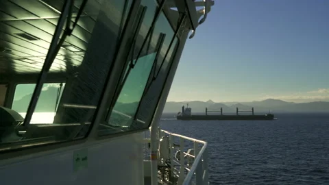 Cargo ship. Bridge windows from outside. Bulker sails in background Stock Footage 169972246