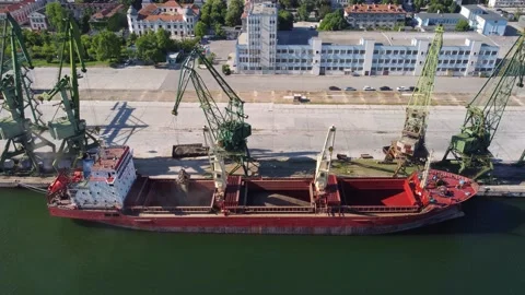Cargo ship bulk carrier loading in port at sunset Stock Footage 195688267
