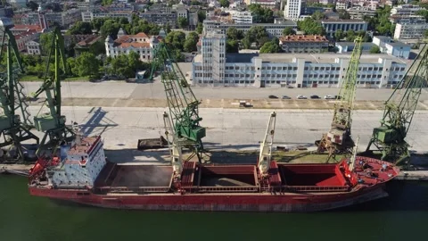 Cargo ship bulk carrier loading in port at sunset Stock Footage 196687006