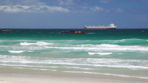 Cargo Ship Close to the Breaking Waves on the Beach Beach Video stock 23772739
