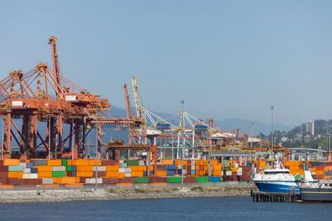 Cargo ship at container port loading global trade goods Stock Photos