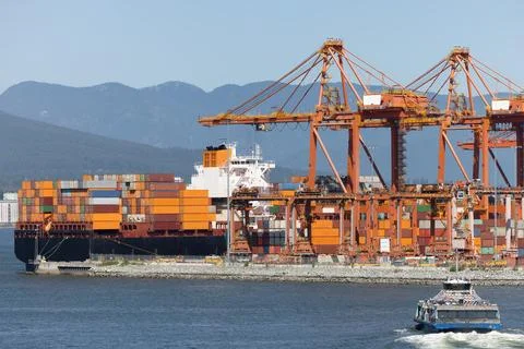 Cargo ship at container port loading global trade goods Stock Photos