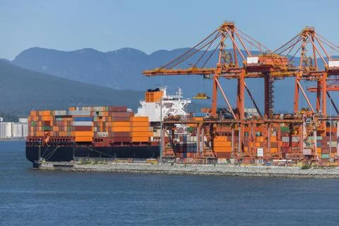 Cargo ship at container port loading global trade goods Stock Photos