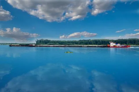 Cargo ship with containers on the Danube river, Europe. Goods transport. Stock Photos