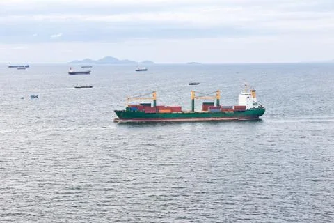 Cargo ship with containers sailing on the sea Stock Photos