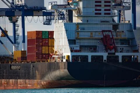 Cargo ship with containers in seaport Stock Photos