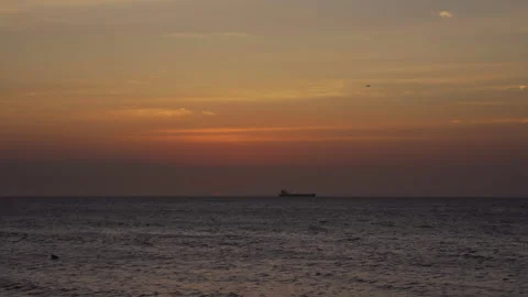 Cargo Ship Cruising In The Ocean With Plane In The Sky At Sunset In Santa Stock Footage 331415933