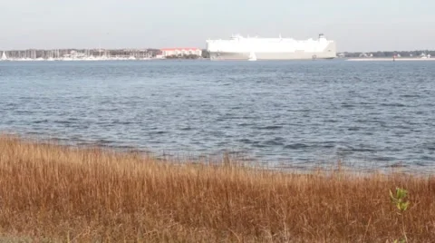 Cargo Ship in the Distance Pull From Port  Stock Footage 45580797