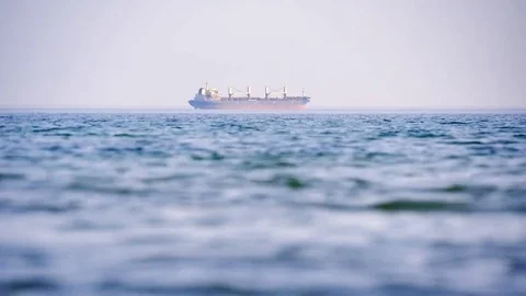 Cargo ship in the distance of the sea Stock Footage 78628862