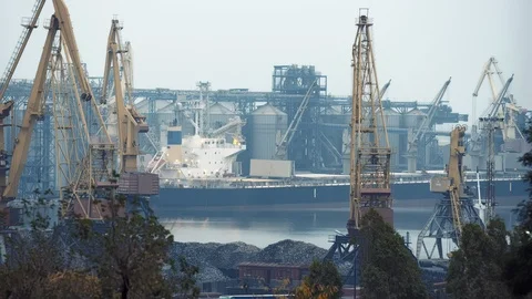 Cargo ship docked in harbor getting loaded up at sunrise Odessa Ukraine Stock Footage 122536230